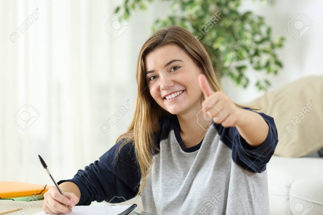 Happy student looking at camera with thumbs up